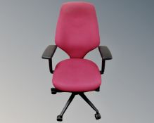An office armchair upholstered in maroon fabric