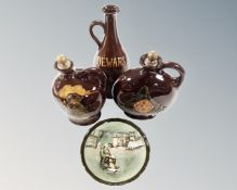 Four pieces of Royal Doulton to include three Dewars Scotch whiskey decanters with stoppers,