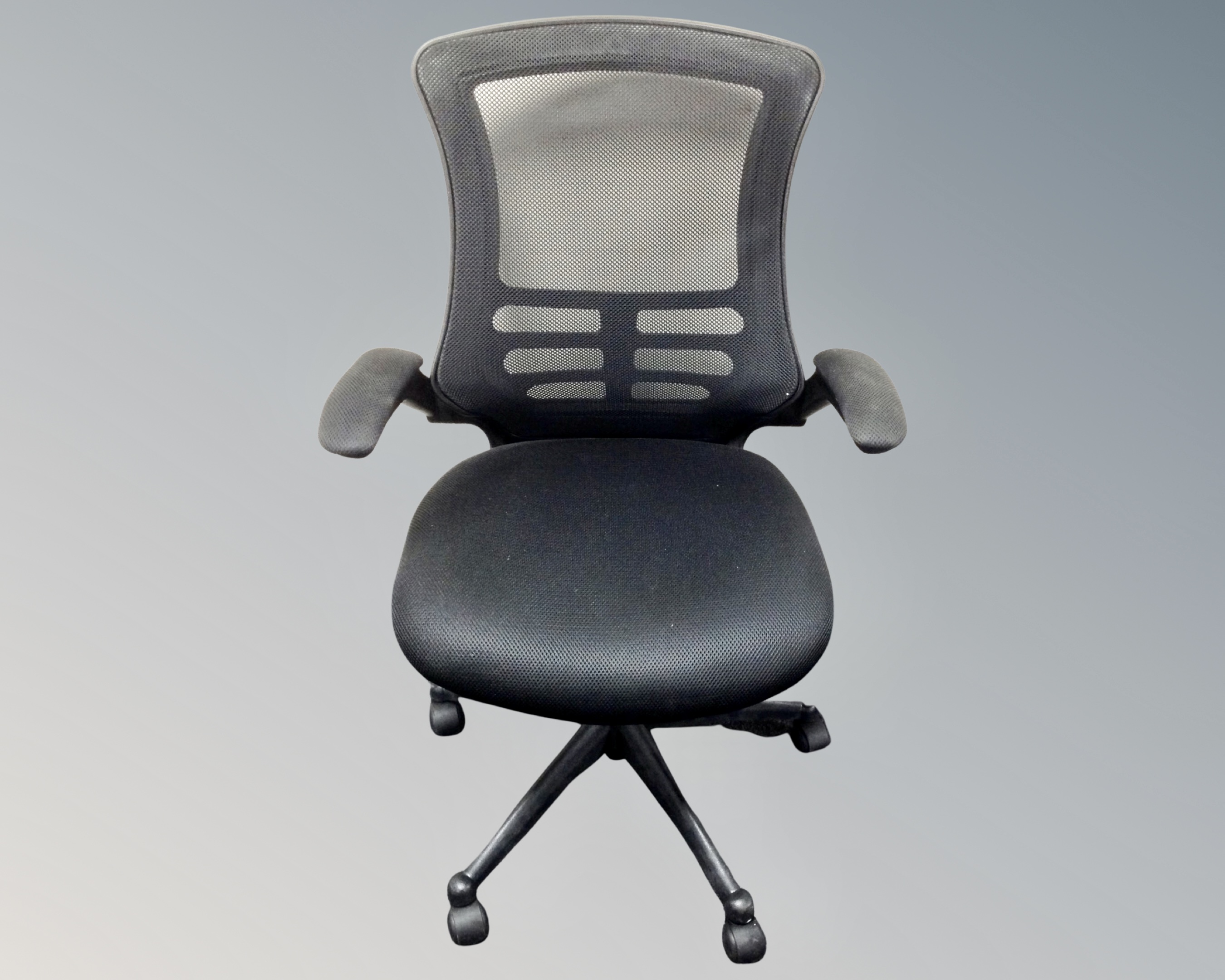 An adjustable office armchair in black mesh fabric