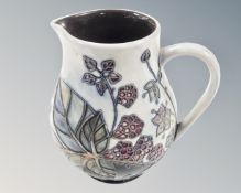 A Moorcroft bramble patterned jug (height 15cm)