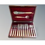 An Edwardian mahogany canteen of fourteen-piece fish cutlery set