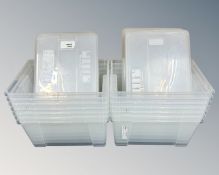 A collection of 14 IKEA plastic storage boxes with lids.