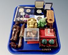 A tray containing commemorative coins, treen, a pair of boxed Chinese stress balls,