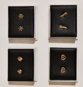 A collection of boxed gold plated earrings.