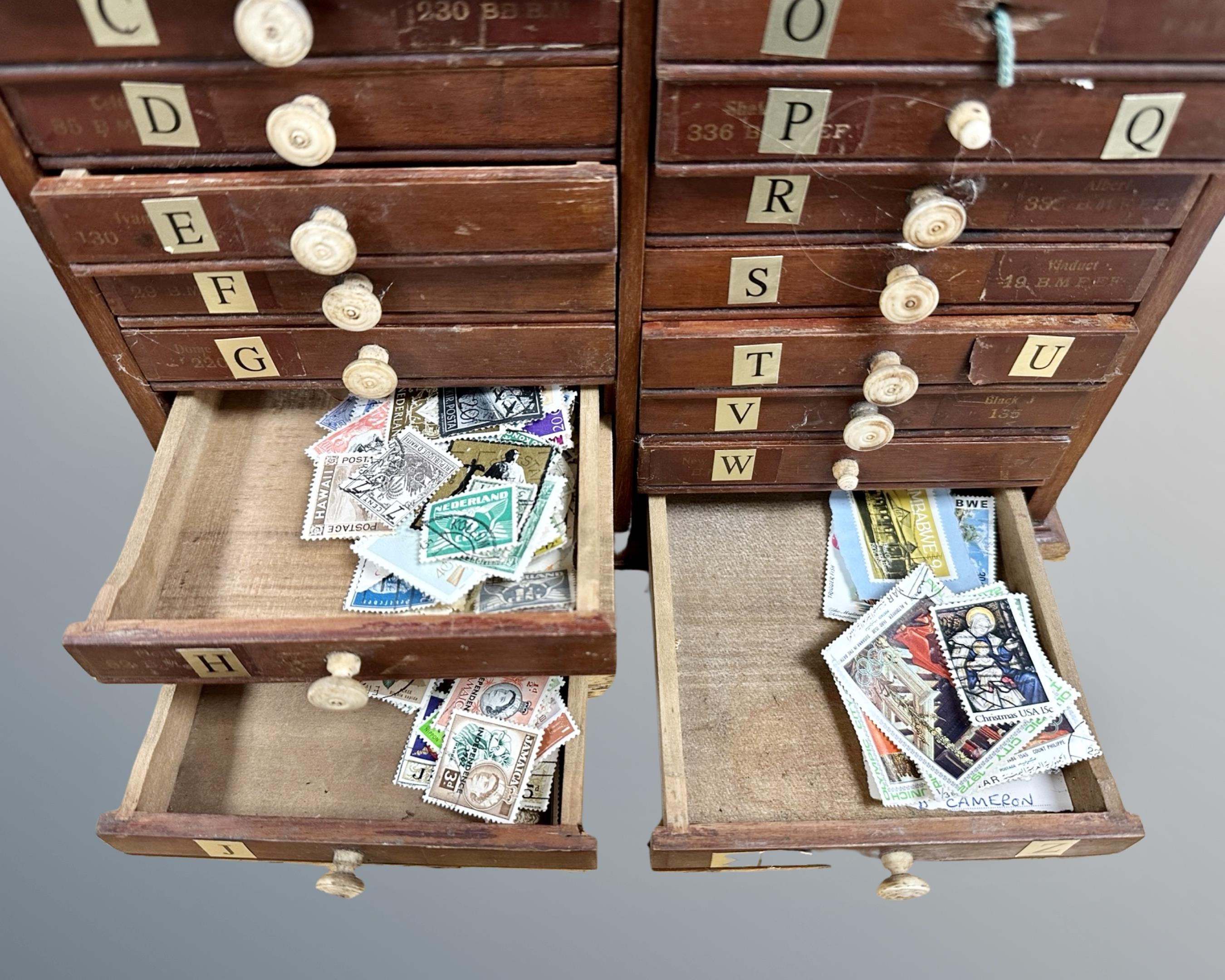 An early 20th century sample cabinet, fitted with twenty-four drawers, containing stamps, - Image 2 of 2