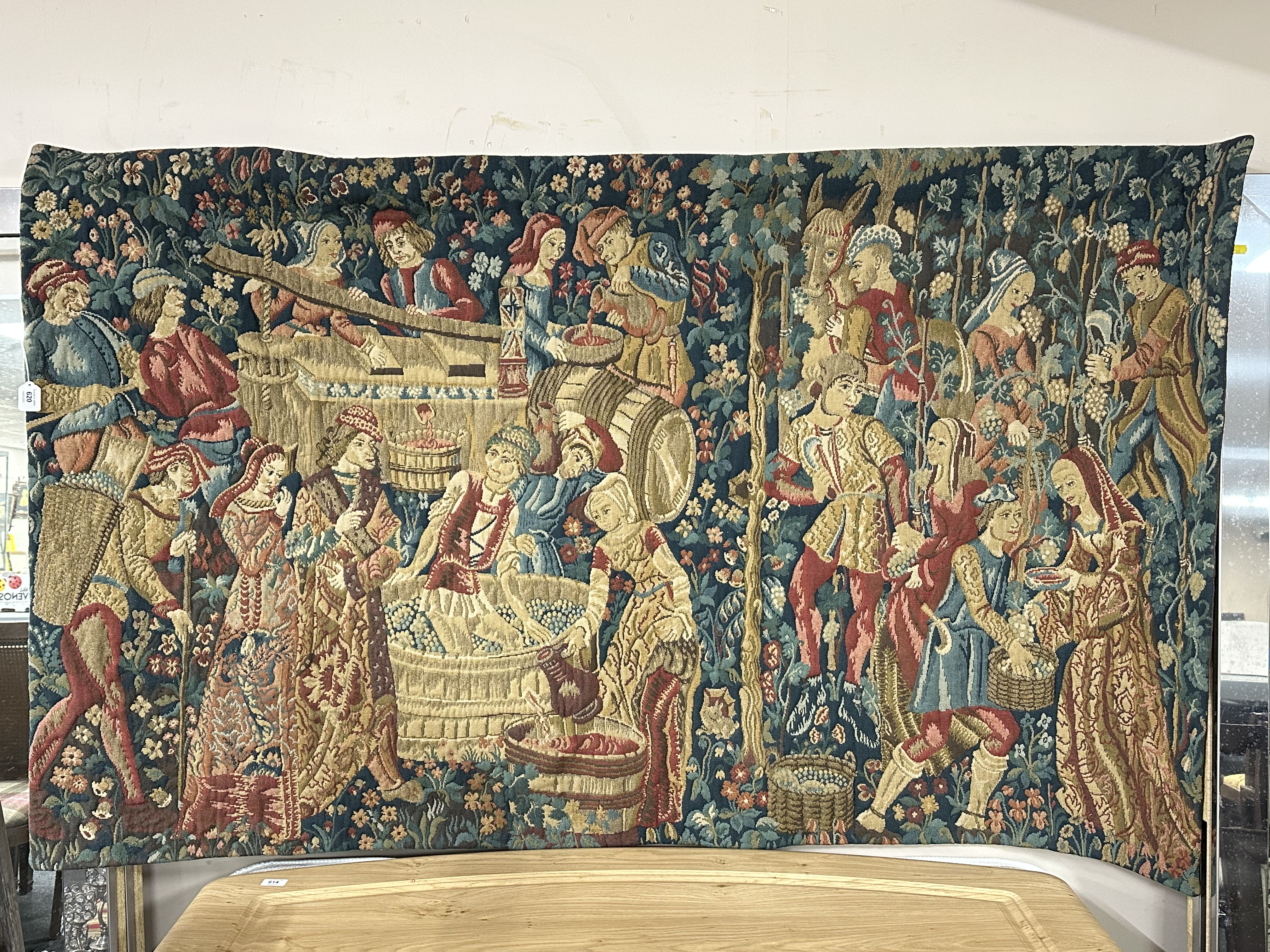 A wall tapestry depicting a Tudor feast.