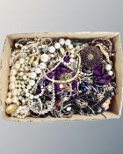 A box containing a large quantity of costume jewellery, bead necklaces etc.