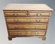 A George III inlaid oak five drawer chest on bracket feet, 104cm wide by 52cm deep by 90cm high.