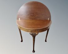 A Victorian style mahogany turnover top D-shaped table.