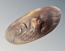 A carved beech wall bracket depicting a bird in flight.
