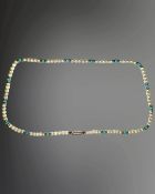 An Edwardian 9ct gold cultured pearl and turquoise single-strand necklace, length 36cm.