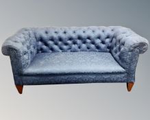 An Edwardian drop end buttoned back club settee in blue fabric