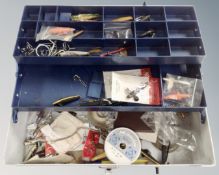A concertina box containing fishing accessories including lures, hooks etc.