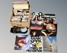 A box of vinyl records to include LP's and 7" singles, Thin Lizzy, Frank Zappa, Now compilations,