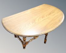 An Ercol drop leaf coffee table on turned legs