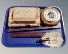 A tray containing a circular walnut barometer,