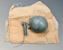 A box containing two vintage canvas duffel bags together with a military helmet and a torch.