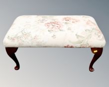 A footstool on Queen Anne style legs