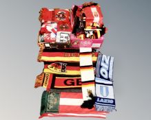 Two boxes containing a large quantity of sports scarves.