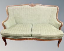 A contemporary French style wooden framed salon settee
