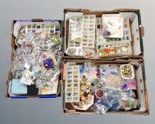 Three boxes containing a large quantity of costume jewellery and loose beads.