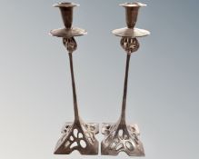 A pair of silver plated Arts and Crafts candlesticks.