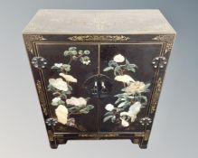 An early 20th century Japanese hardstone inlaid double door low cabinet.