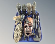 A group of African wood carvings including masks and figures etc.