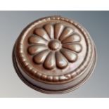 A circular copper jelly mould.