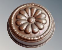A circular copper jelly mould.