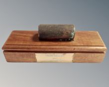 A copper bolt mounted on teak stand with plaque inscribed Trincomalee 1817, original teak and bolt.