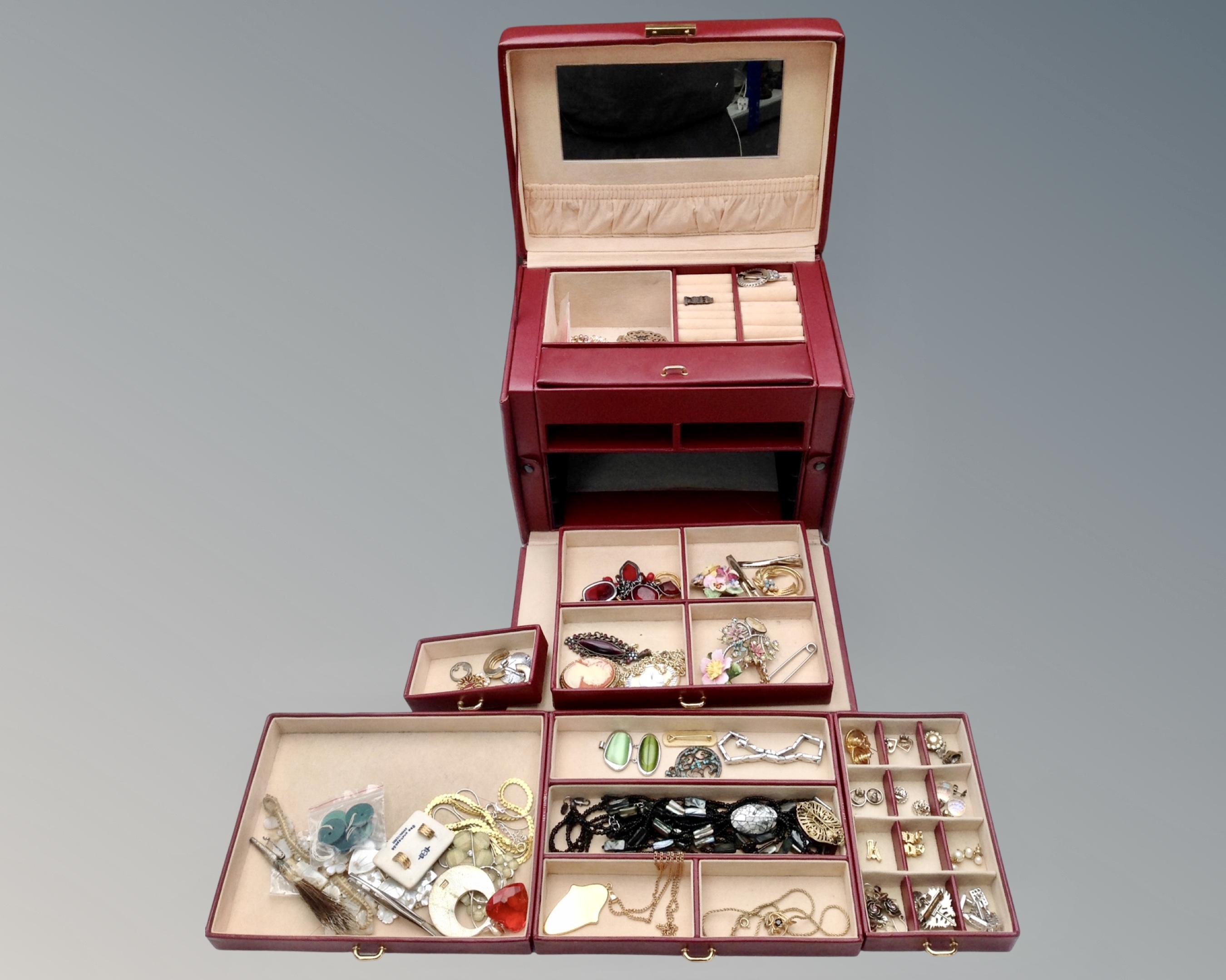 A contemporary jewellery chest containing costume brooches, earrings, necklaces etc.