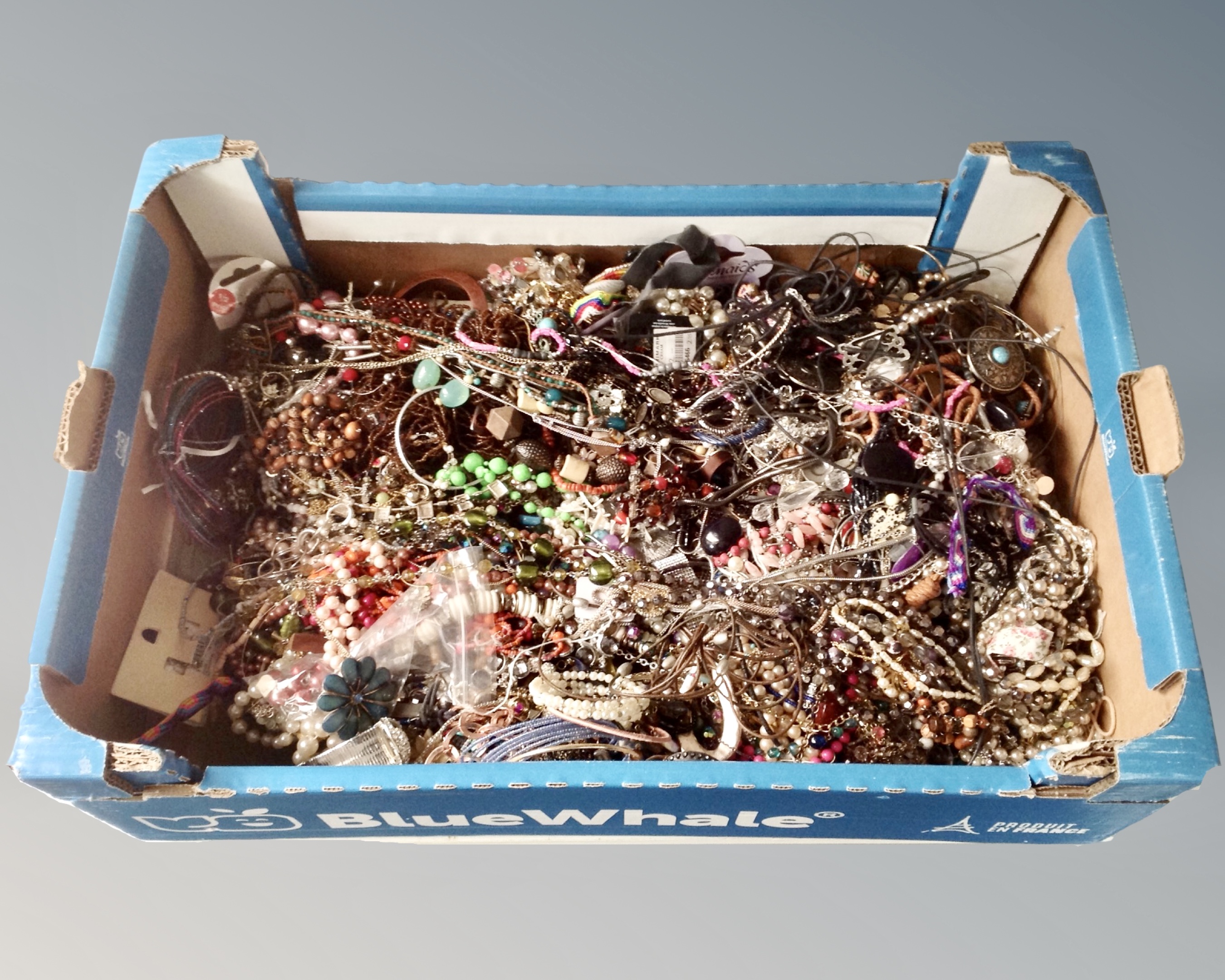 A box containing a large quantity of costume jewellery, necklaces, bead,