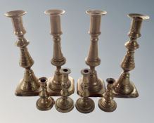 Four pairs of brass candlesticks.