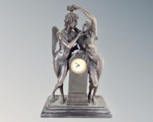 An Art Nouveau style patinated metal mantel clock on black marble base.