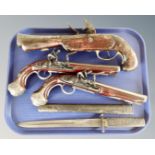 A pair of reproduction flintlock style pistols,