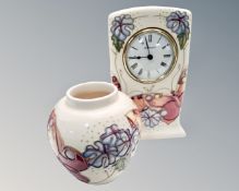 A Moorcroft pottery mantel timepiece (height 16cm),