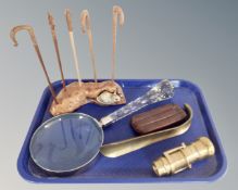 A tray containing large crystal magnifying glass, brass shoehorn, leather cigar case,