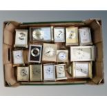 A box of contemporary mostly brass mantel timepieces and carriage clocks.