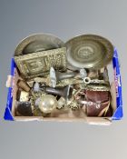 A box containing assorted brassware including chargers, candlesticks,