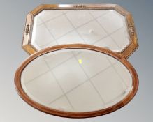 An Edwardian oak framed octagonal mirror together with a further inlaid mahogany oval mirror.