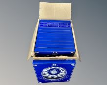A box containing a collection of boxed Ringtons blue and white plates.