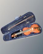 A Primavera half size violin with bow, in case.