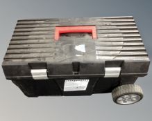 A black toolbox on wheels.