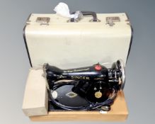 A vintage Singer electric sewing machine with lead and pedal in box.