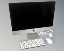 An Apple iMac computer with keyboard and mouse, circa 2014, with 8GB memory and 500GB hard drive.