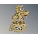 A Shatz gilt figural mantel clock depicting a man with stallion.