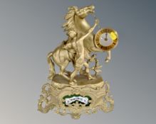 A Shatz gilt figural mantel clock depicting a man with stallion.