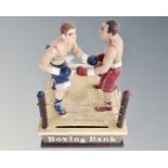 A cast iron novelty boxing money bank.