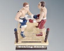 A cast iron novelty boxing money bank.